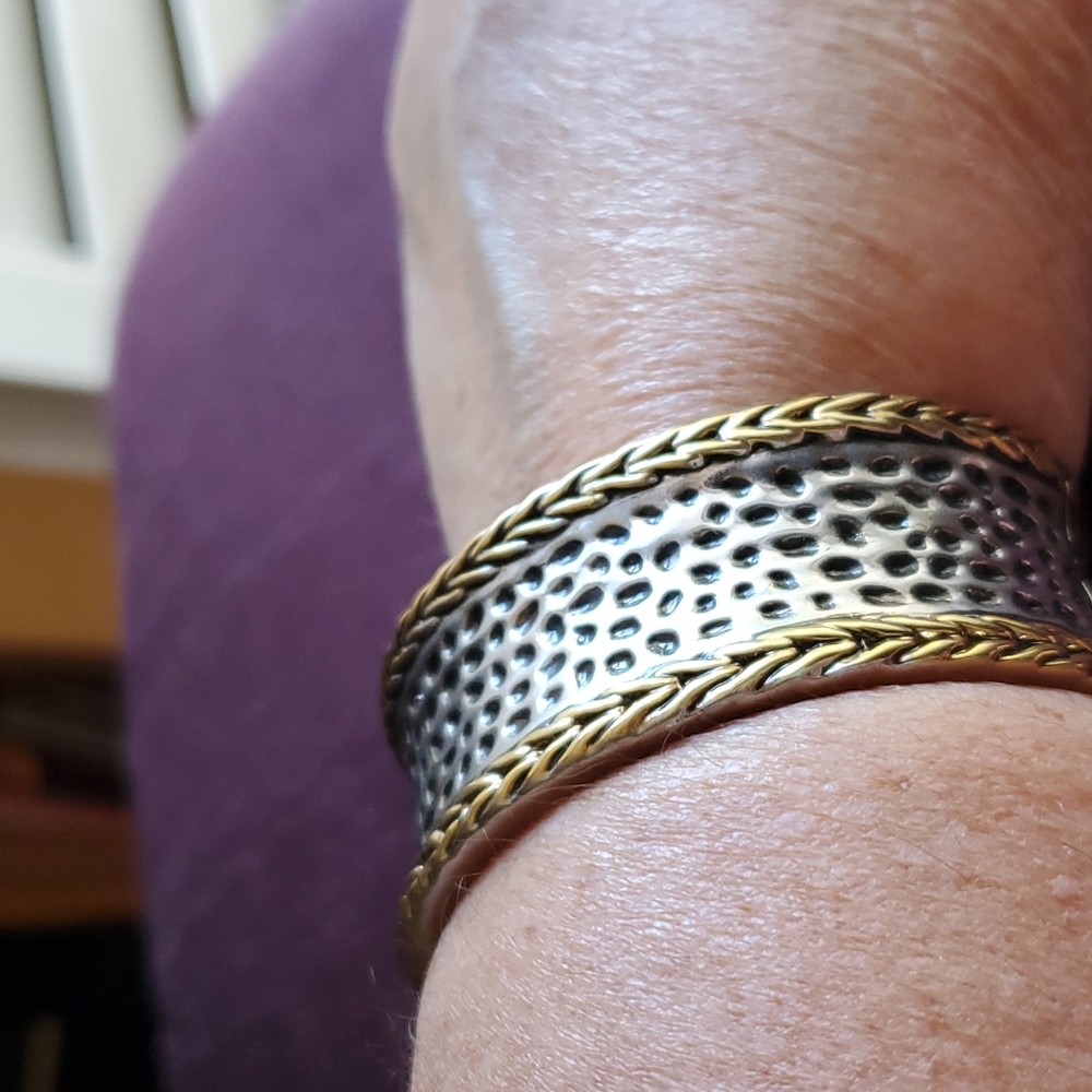 Bangle style bracelet with spring loaded closure.